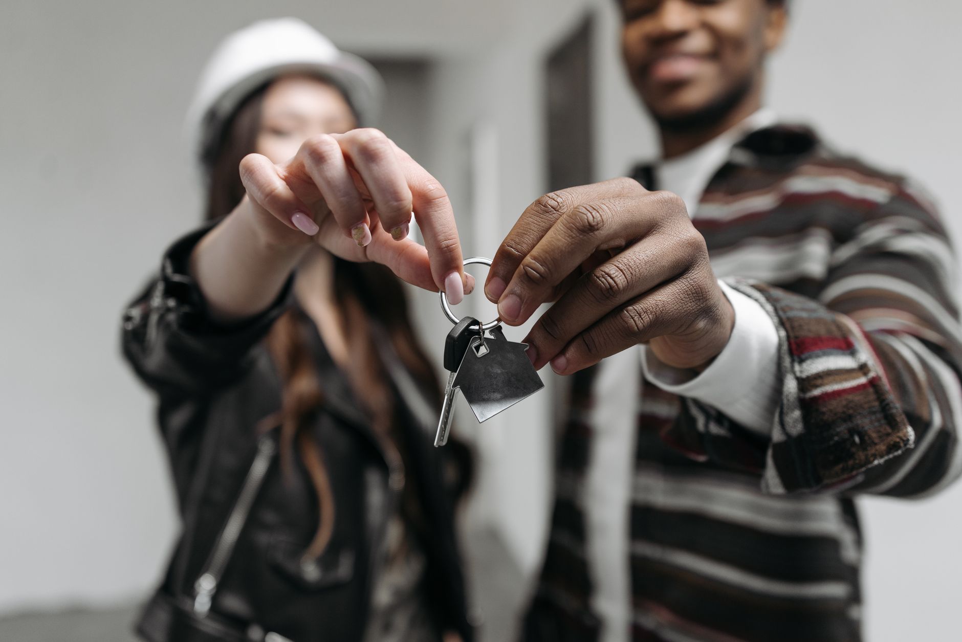 New homeowners with keys, representative of an NRI buying in Dholera